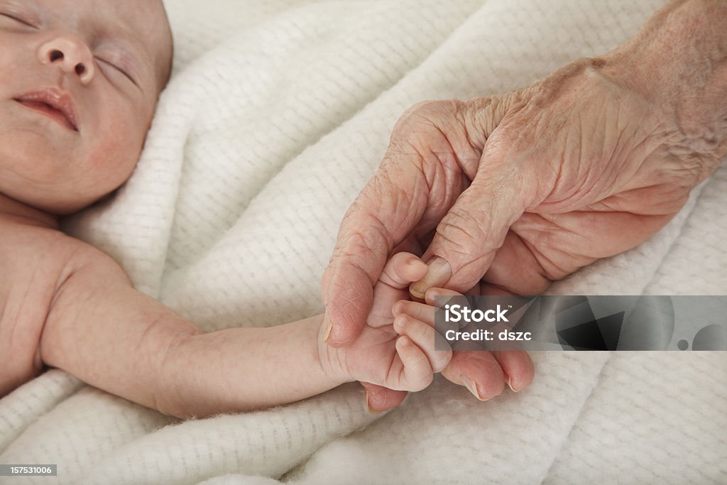 sleeping baby holding great grandmother's hand Baby - Human Age Stock Photo