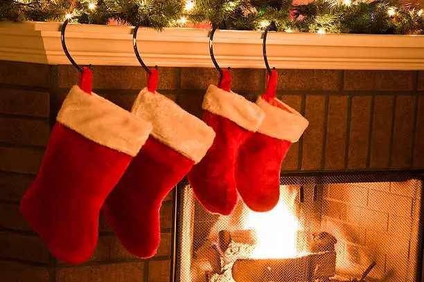 Christmas Stockings hung on Mantel by Holiday Season Fireplace