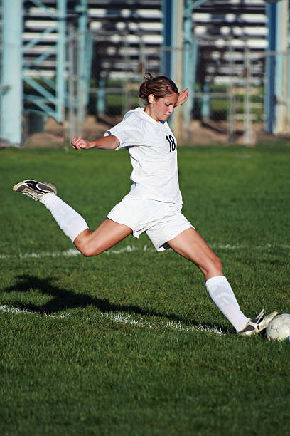 istock Beautiful Female Soccer Player Flying into Power Kick with copyspace 157531069