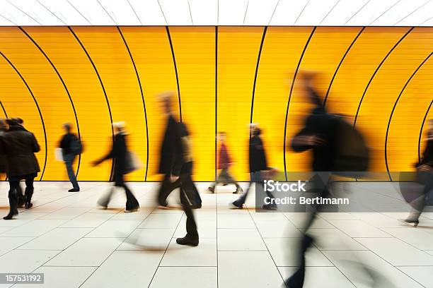 People Blurry In Motion In Yellow Tunnel Down Hallway Stock Photo - Download Image Now
