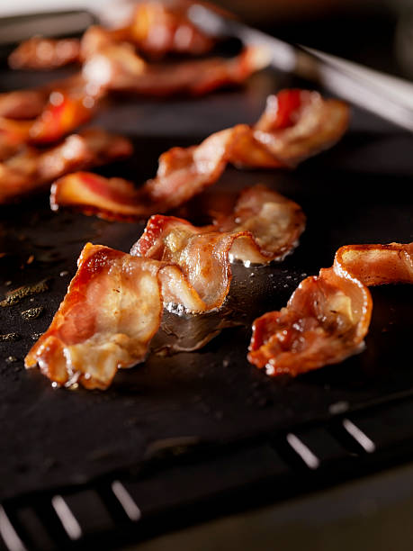 Bacon Frying on The Grill  griddle stock pictures, royalty-free photos & images