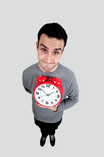 istock Young men holding red alarm clock. 157531394