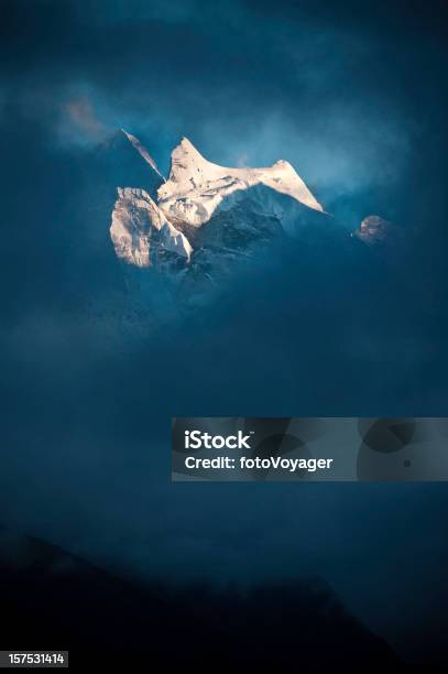 Sunlit Snow Himalaya Peak Dark Swirling Storm Cloud Khumbu Nepal Stock Photo - Download Image Now