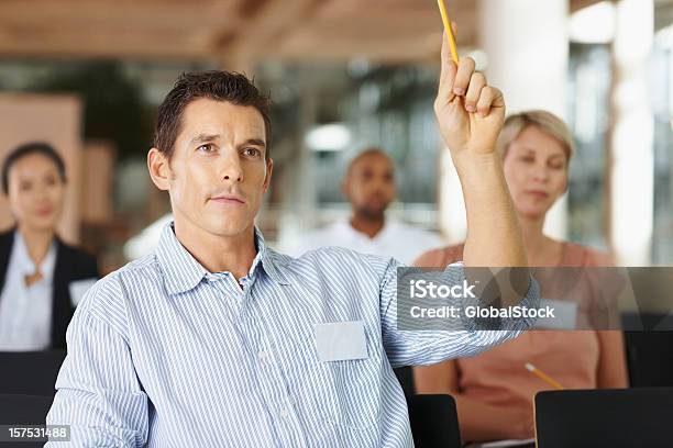 Businessman Asking A Question In Meeting Stock Photo - Download Image Now - Asking, Hand Raised, 30-34 Years