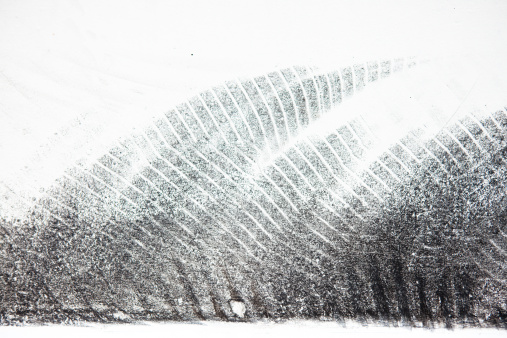 Closeup fo some bycicle tyre tread on a white surface.