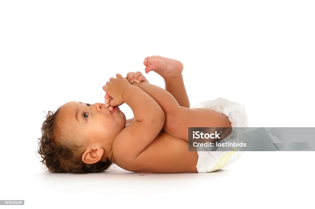 Biracial Baby Sucking his Toes Isolated on white A biracial baby sitting sucking his toes isolated on white Baby - Human Age Stock Photo