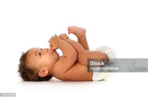 Biracial Baby Sucking His Toes Isolated On White Stock Photo - Download Image Now - Baby - Human Age, Diaper, Cut Out