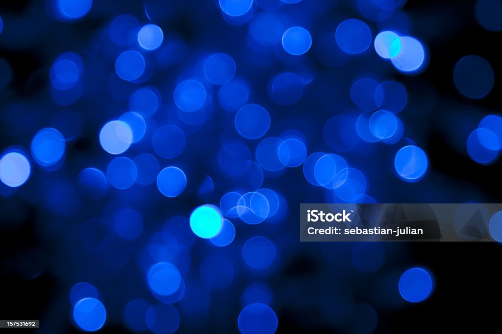 defocused blue light dots against black background  Backgrounds Stock Photo