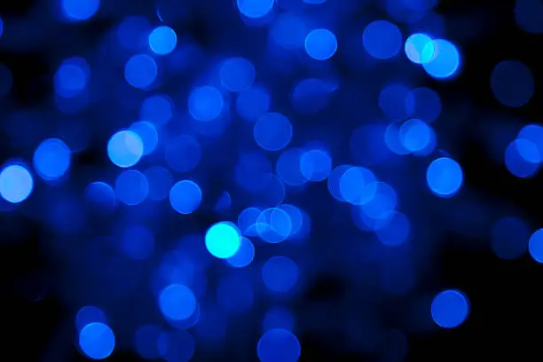 Photo of defocused blue light dots against black background