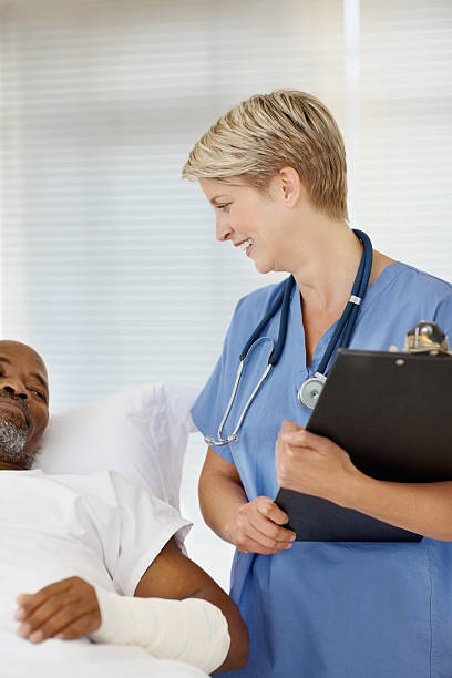 istock Female doctor talking to a patient on bed 157531706