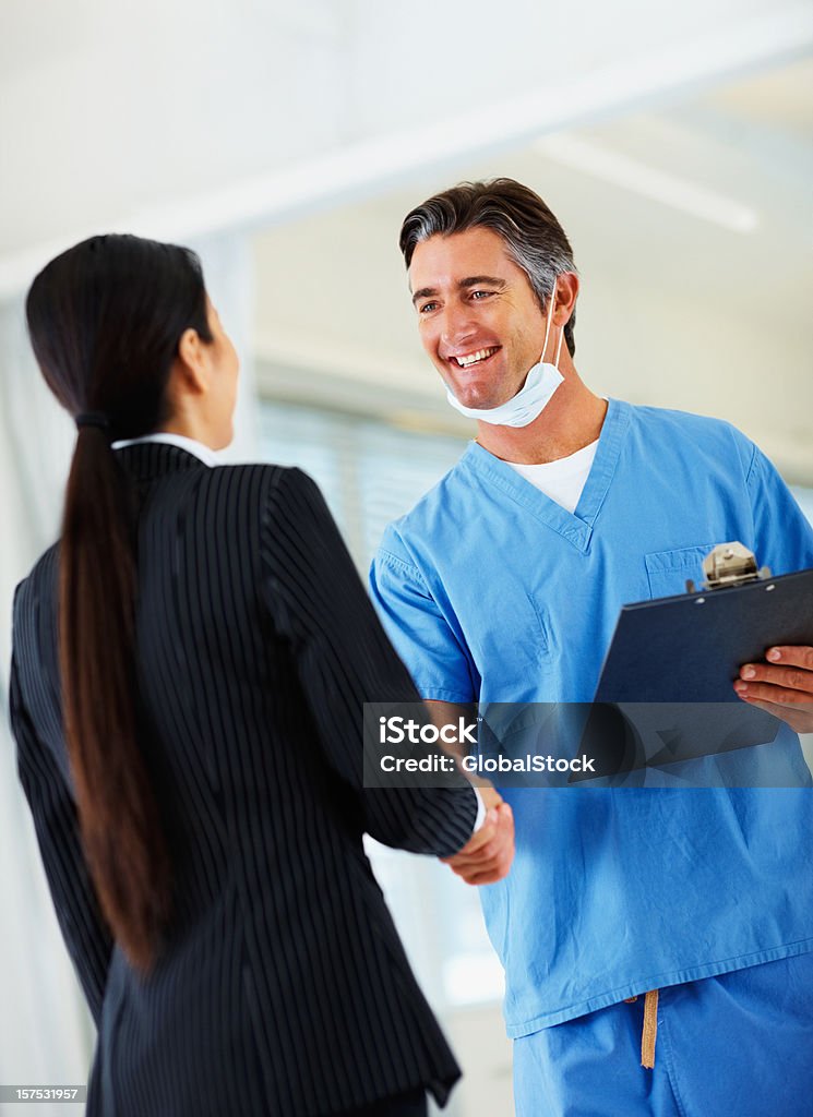 Doctor shaking hands with his colleague  Doctor Stock Photo