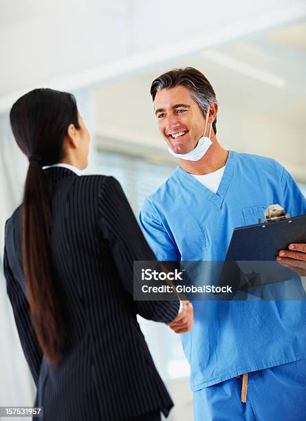 Doctor Shaking Hands With His Colleague Stock Photo - Download Image Now - Doctor, Handshake, 30-39 Years