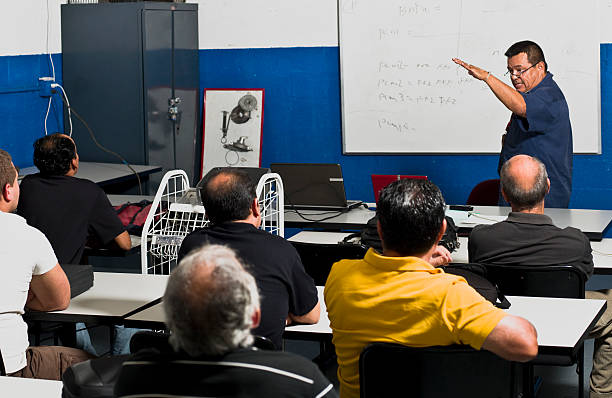 Adult Training Class Hispanic Mechanics at a Training Class (this picture has been taken with a Hasselblad H3D II 31 megapixels camera) nontraditional student photos stock pictures, royalty-free photos & images