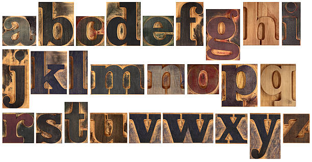 Wooden typeset alphabet The letters of the alphabet in small wooden single typefaces of a bold font with serifs. These single blocks where used to compose and print words and phrases. Isolated on white. Other XXL letters in:http://i227.photobucket.com/albums/dd10/sdeinobili/printingpress.jpg letterpress photos stock pictures, royalty-free photos & images