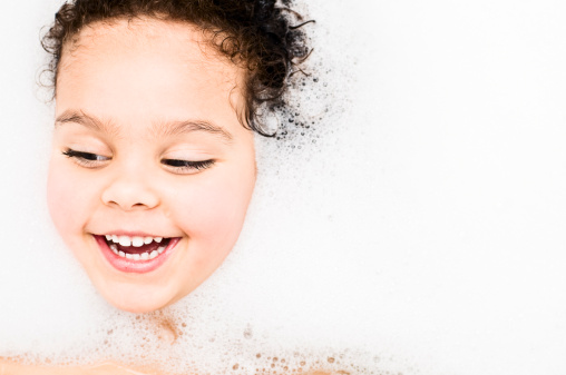 Royalty Free stock photo of 3 years old girl having bubble bath.
