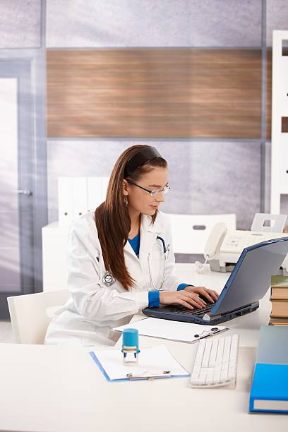 Portrait of young female doctor at office stock photo