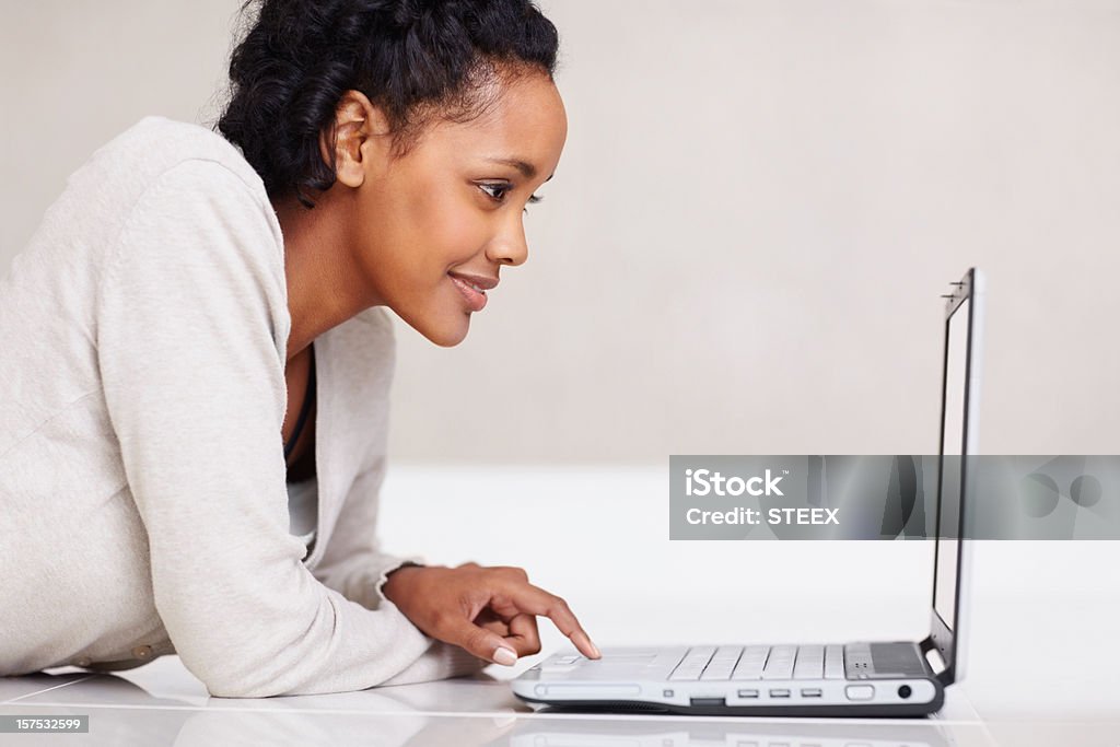 Młoda kobieta pracuje na laptopie - Zbiór zdjęć royalty-free (20-24 lata)