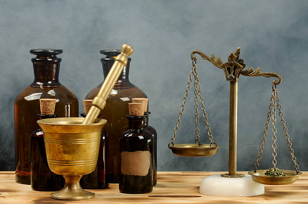 Vintage Pharmacy Vintage pharmacy. Medicine producing process.  Some herbs on scale. alchemy photos stock pictures, royalty-free photos & images