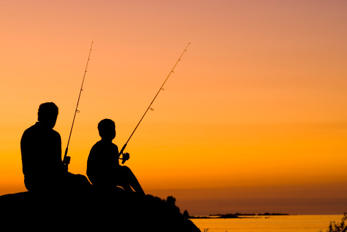 Little Boy And His Grandfather Fishing At Sunset - III