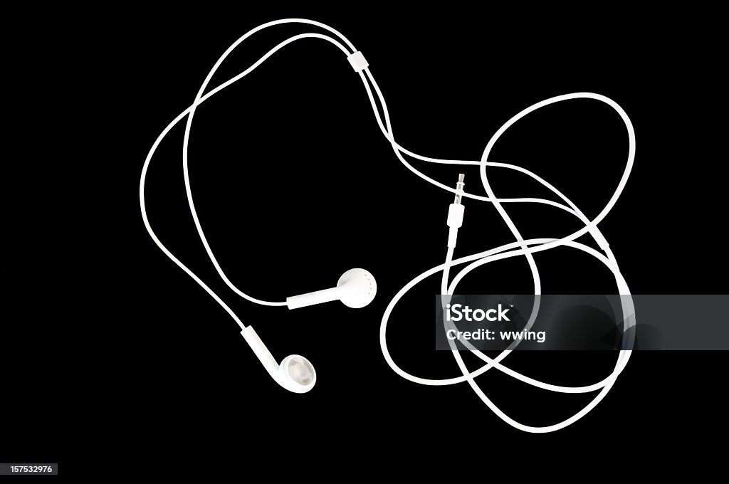 White Earbuds on Black Brilliant white earbuds on a black background with copy space. Headphones Stock Photo