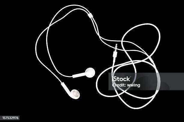 White Earbuds On Black Stock Photo - Download Image Now - Headphones, Cable, Cut Out