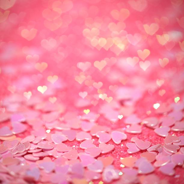Pink confetti hearts with hearts bokeh effect stock photo