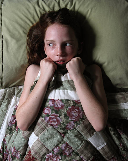 Little girl in bed afraid of the boogey man, or something else scaring her