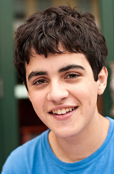 istock hispanic teenage boy smiling 157533040