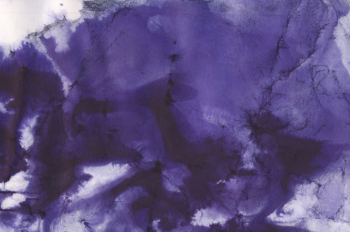 Abstract wet  purple watercolor background on white watercolor paper. My own work.