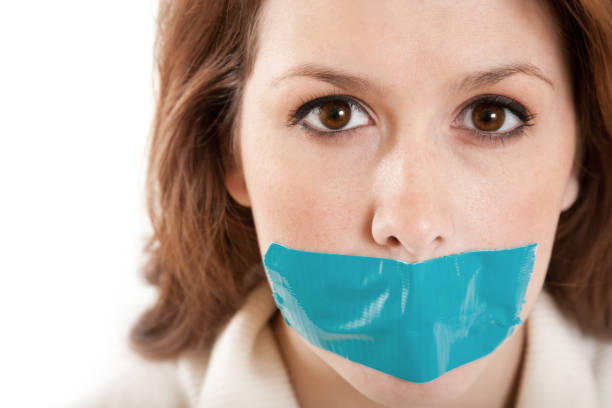 istock woman with tape covering mouth 157533192