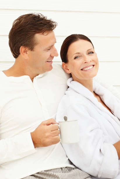 istock Mature man holding coffee cup sitting with his wife 157533501