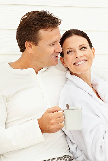 istock Mature man holding coffee cup sitting with his wife 157533504