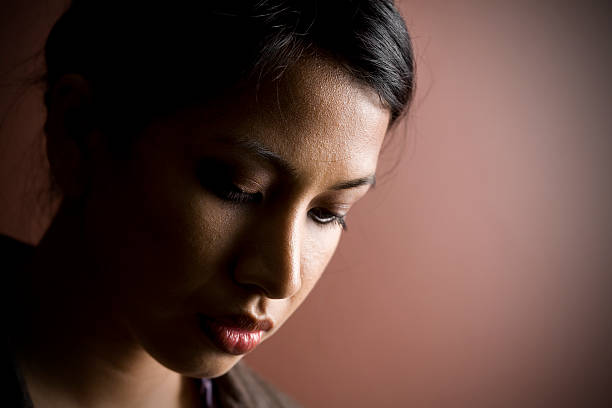 istock Moody Asian Woman Looking Down 157533800