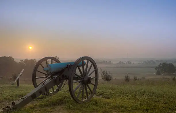Dawn over the Gettysburg battlefield, cannon standing guard.