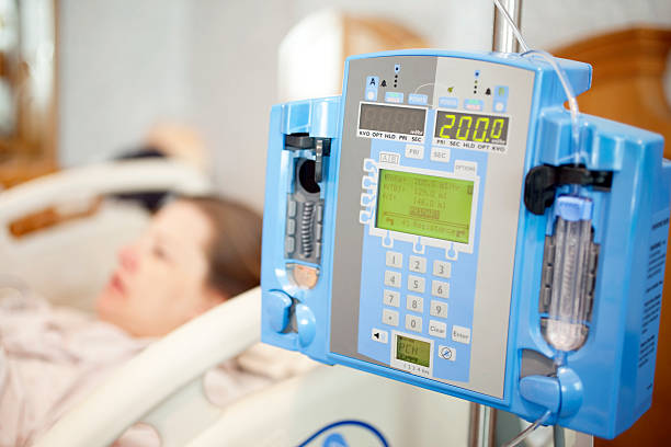 Intravenous IV Drip Pump In a Hospital Room with Patient stock photo