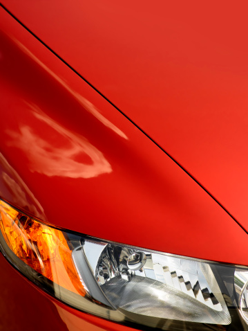 Detail of a tail light of a vintage italian red sport car