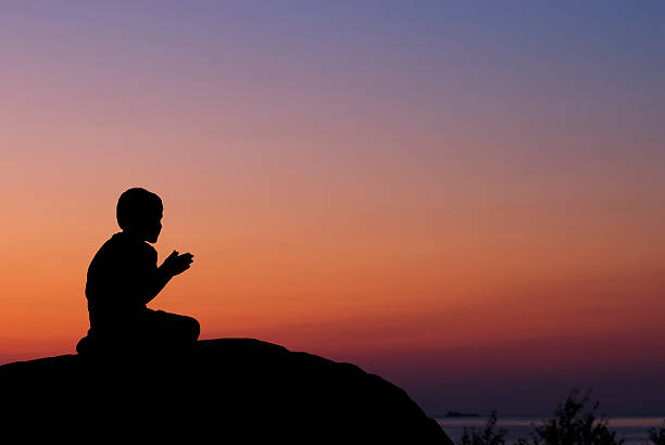 istock Little Boy Praying At Sunset - I 157534334