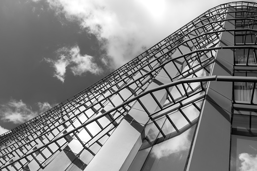 Black and white reflection of office buildings on the glass wall, background with copy space, full frame horizontal composition