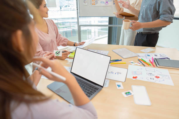 istock ux developers and ui designers listening to mobile app presentations in conference in front of laptop 1575383438