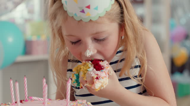 greedy girl eating birthday cake naughty child overeating taking moutfhful excessive hunger at party 4k footage