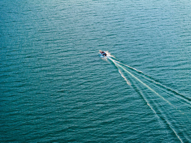 istock Blue lake and speedboat overlooking 1575397555