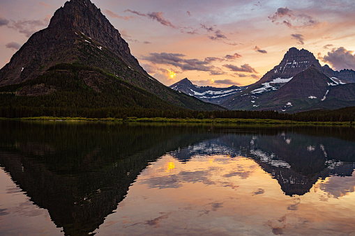 Mount Wilbur and the Nearby mountains on the foreground with twilight on the background in Glacier National Park