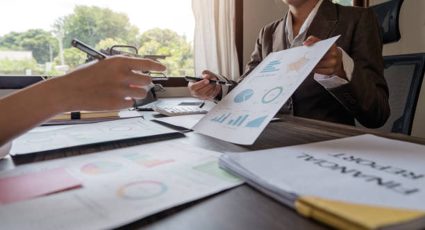 istock Close up of Business team analyzing income charts and graphs with modern laptop computer. Business analysis and strategy concept 1575417172