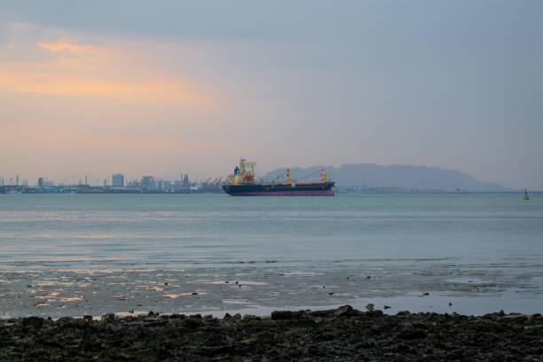 istock Colourful sunset sky over the sea with silhouette boat. 1575510329