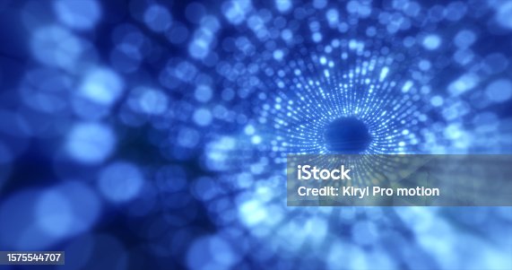 istock Tunnel of blue energy particles blurred bokeh glowing bright abstract background 1575544707