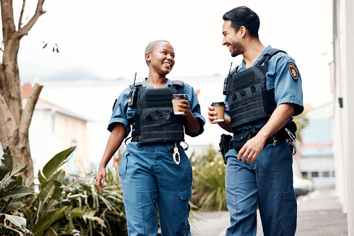 Police, conversation and team on a coffee break after investigation or patrol for law protection in city or town. Criminal, happy and legal service guard or security smile for justice enforcement