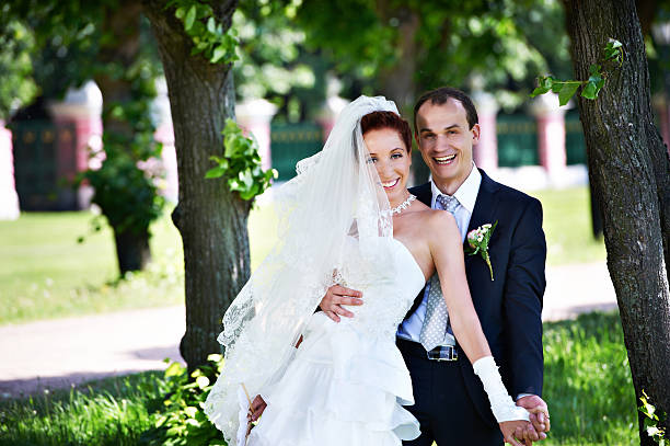 istock Joyful groom and bride in park 157557386
