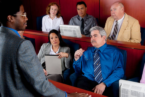 Members of diverse jury listening to an attorney in courtroom Members of diverse jury in the jury box listening to an african american attorney in the courtroom. You might also be interested in this: juror stock pictures, royalty-free photos & images