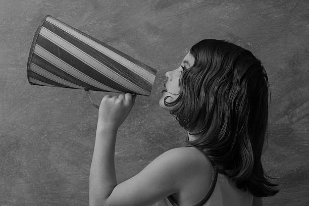 Retro style girl with megaphone  beckoning photos stock pictures, royalty-free photos & images