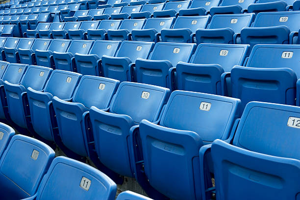 An empty blue arena seats with numbers stock photo